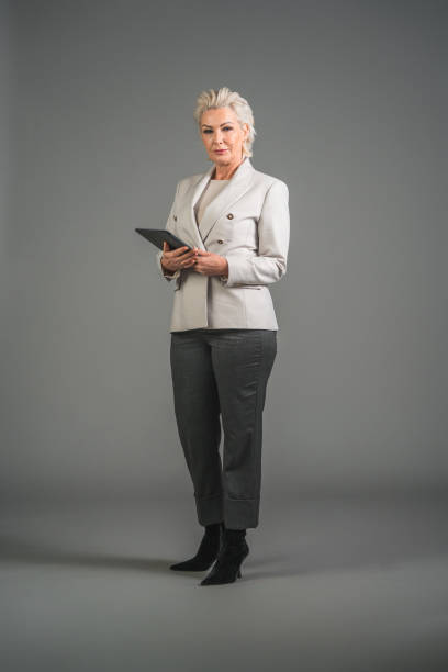 istock Confident Mature Caucasian Female Office Manager With A Digital Tablet 1466099379