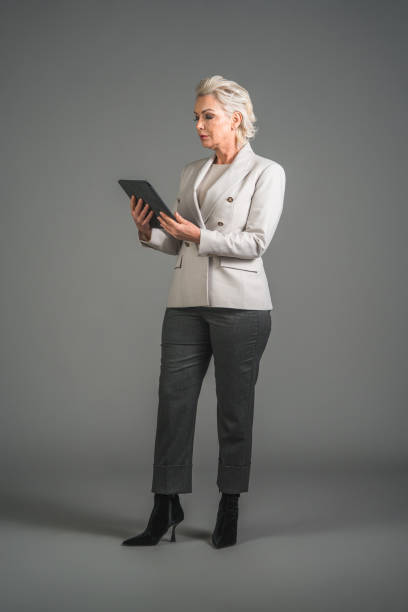 istock Self-Assured Mature Caucasian Office Worker Using A Digital Tablet 1466099426