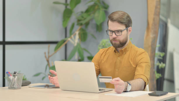 istock Tense Beard Young Man with Online Payment Failure in Office 1466099505