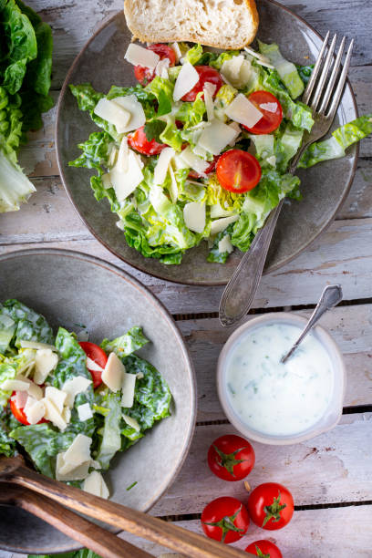 Green salad with tomatoes, bread and parmesan cheese stock photo
