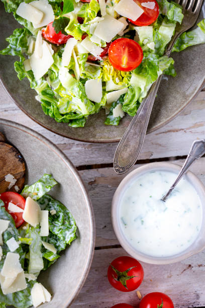 istock Green salad with tomatoes, bread and parmesan cheese 1466099616