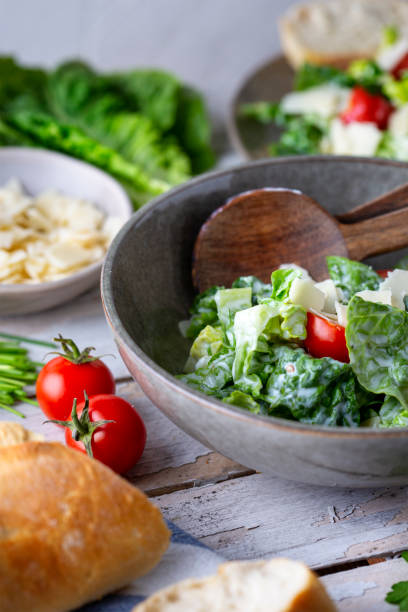 istock Green salad with tomatoes, bread and parmesan cheese 1466099634