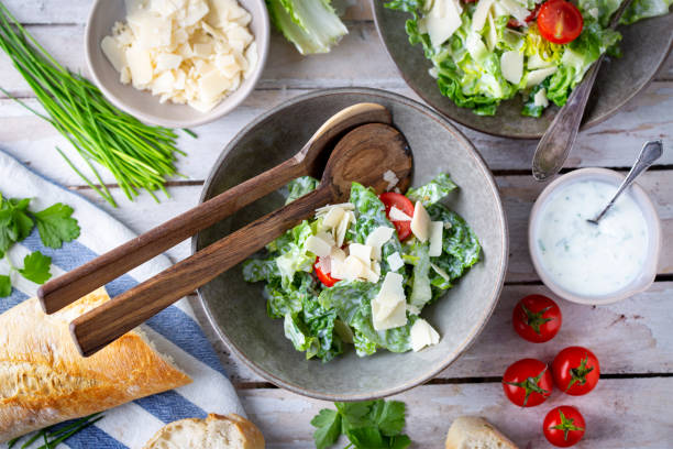istock Green salad with tomatoes, bread and parmesan cheese 1466099649