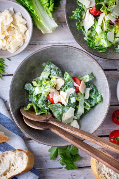 istock Green salad with tomatoes, bread and parmesan cheese 1466099672
