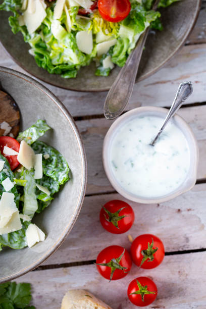 istock Green salad with tomatoes, bread and parmesan cheese 1466099733