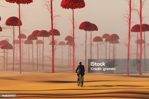 Businessman Cycling In Strange Surreal Landscape Stock Photo - Download Image Now - Surreal, Fantasy, Nature