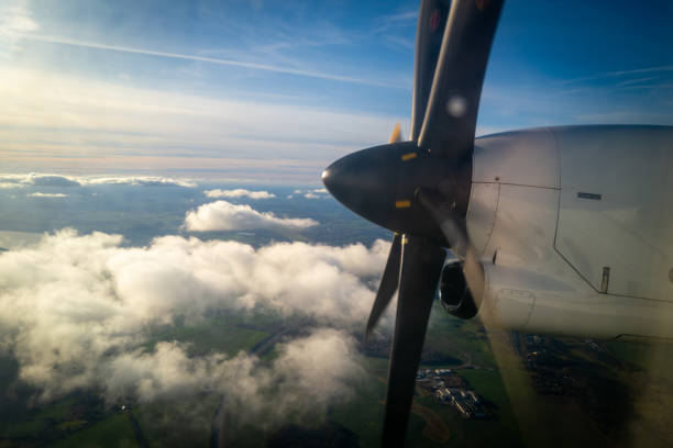 the big propeller of a propeller plane flying above the clouds