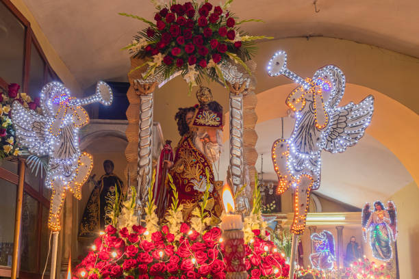 istock Image of St. Christopher with little Jesus dressed in cherry and surrounded by roses, angels and candles on the altar, located in Shupluy, Yungay, Ancash, Peru. 1466105817