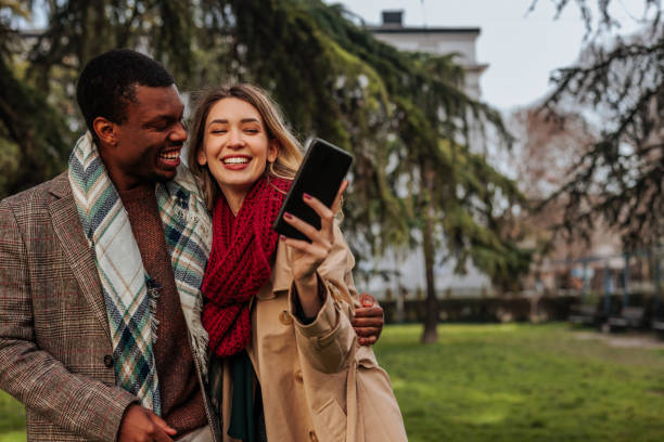 istock Joyful couple taking selfie outside. 1466106421