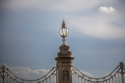 The lamp above the historical gate of the Dolmabahçe Palace in Istanbul and the blue sky in the background