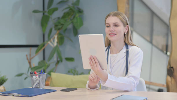istock Young Doctor Talking on Video Chat in Clinic 1466108117