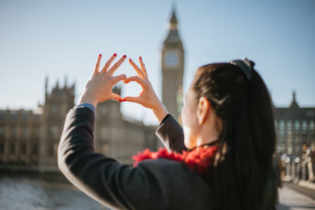 istock Beautiful woman making a heart shape with her hands on Westminster Bridge 1466115903