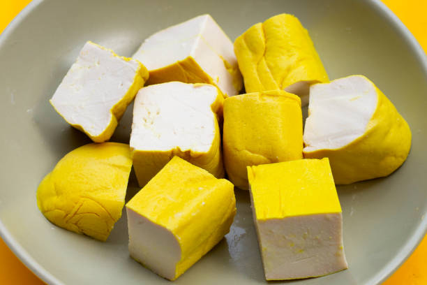 istock Yellow tofu in plate on yellow background. 1466122434
