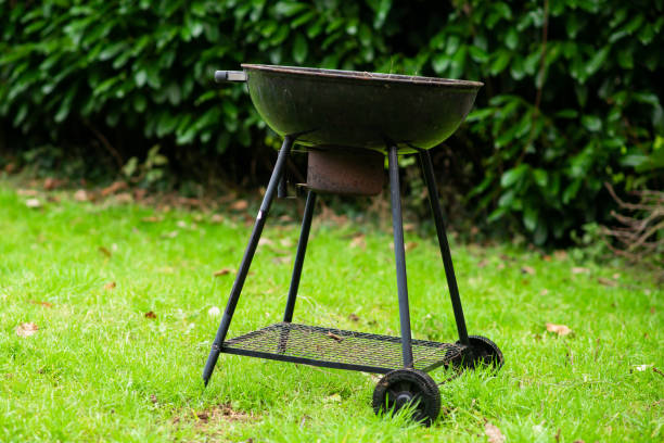 istock Round barbecue grill on green grass. Picnic, grilling concept. 1466127782