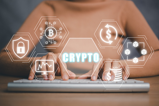 Cryptocurrency concept, Person hand typing on keyboard computer with cryptocurrency icon on virtual screen.