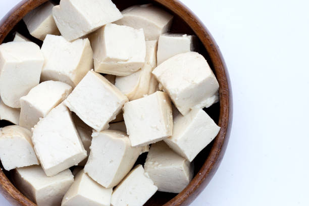 istock White tofu in wooden bowl on white background. 1466129329