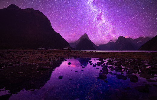 Milky way at Milford Sounds setting behind the Mitre Peak in Fiordland National Park, South Island, New Zealand.