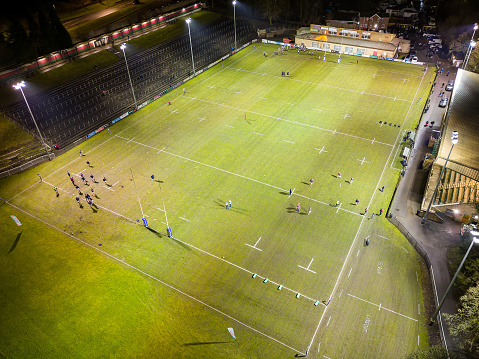 Night time aerial view of the floodlit main Rugby union ground in the Welsh valleys town of Ebbw Vale.
