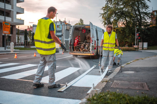 istock Road Maintenance Worker Throwing A Reflecting Glass Powder On A Crosswalk 1466137190