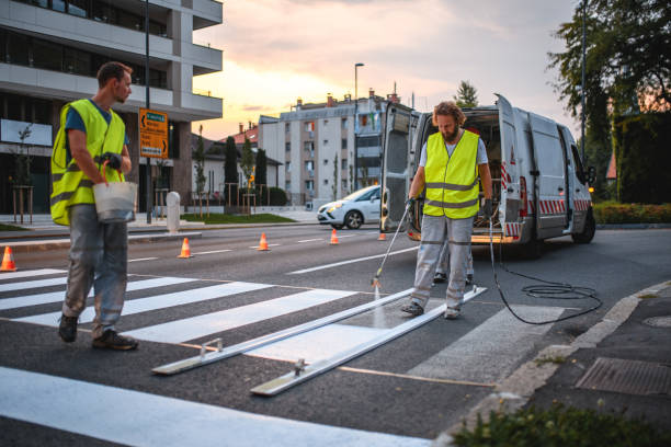 istock Construction Workers Repainting A Crosswalk With A Spray Painter Gun 1466137197