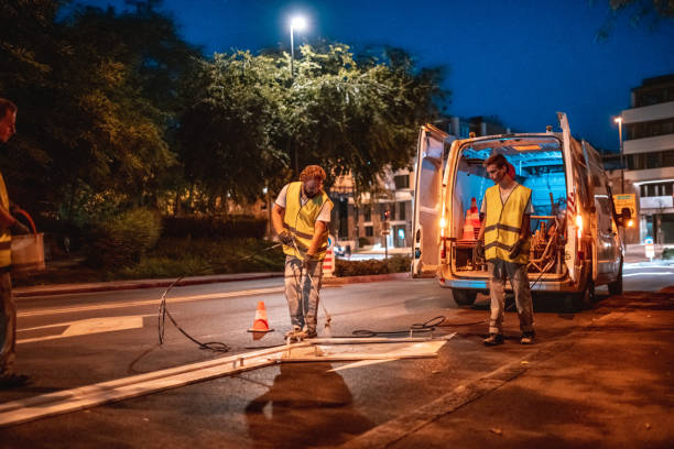 istock Road Construction Workers Spray Painting The Road 1466137262