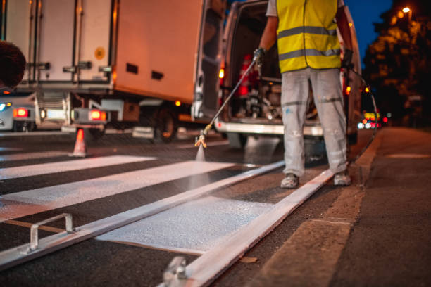 istock Spray Painting A Crosswalk With A Spray Gun 1466137272