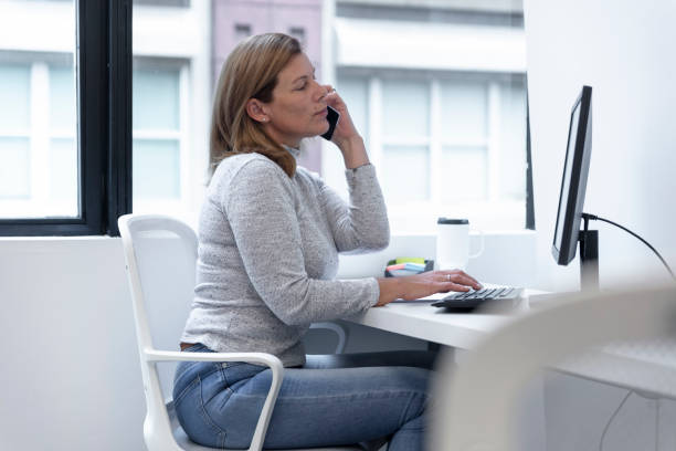 istock Businesswoman using smartphone at office desk 1466138157