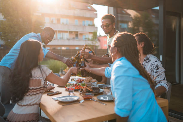 istock Young Couples Drinking Beer Outdoors, Hanging Out And Eating Good Food 1466142473