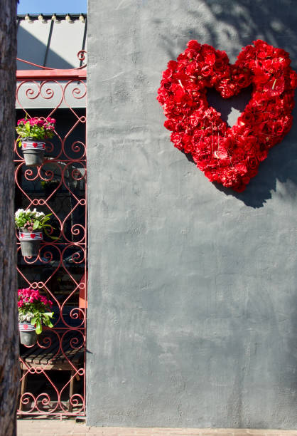 istock Heart shaped wreath hanging on a black wall 1466142523