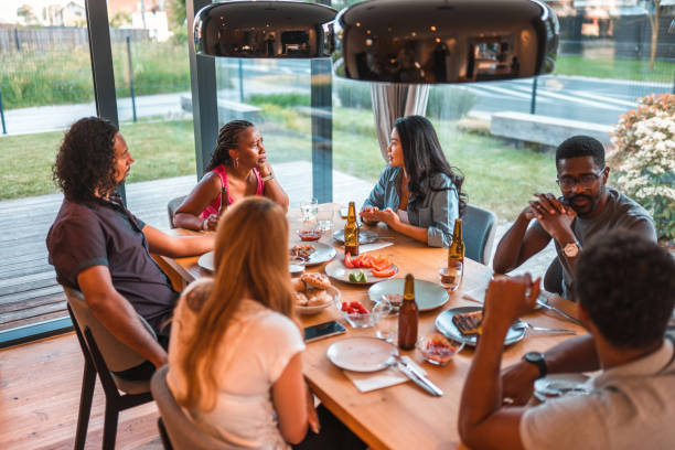 istock Lovely Young Mixed Race Couples Socializing In A Dinner Party 1466142663