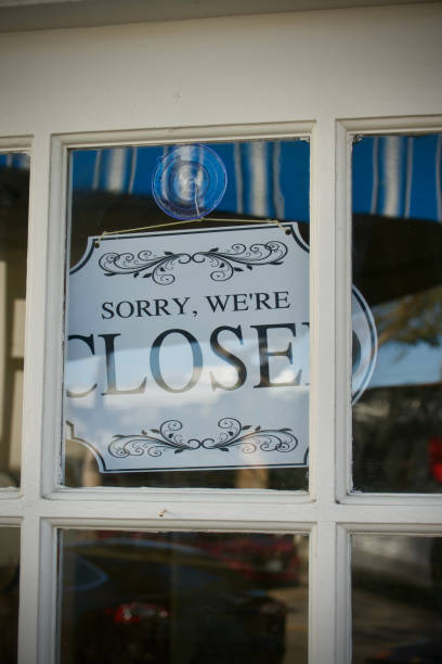 istock Closed sign hanging in the shop window 1466142993