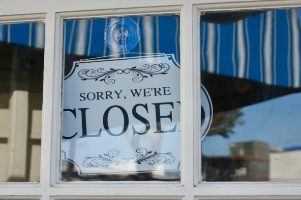 istock Closed sign hanging in the shop window 1466143004