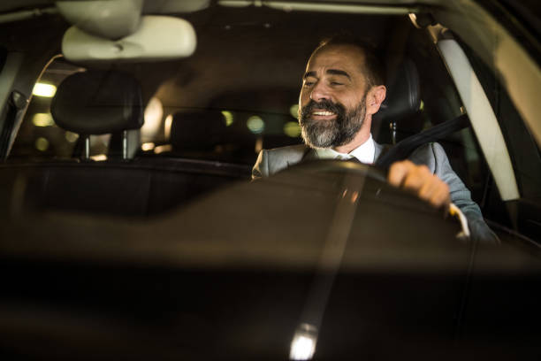 istock Mid aged man driving his car and having fun. 1466148502