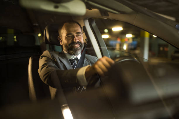istock Mid aged man driving his car in public car garage. 1466149174