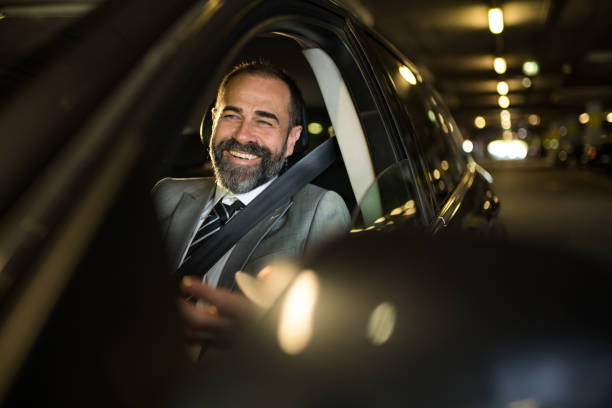 istock Mid aged man driving his car in public car garage. 1466149795