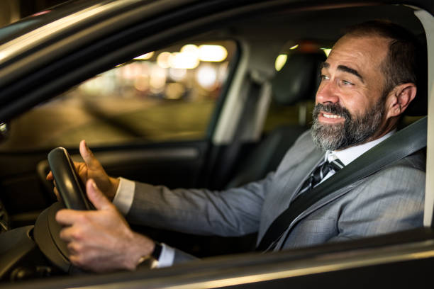 istock Happy mid aged man driving his car. 1466151538