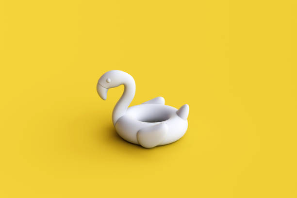 istock Inflatable white flamingo isolated on yellow background. 1466153683