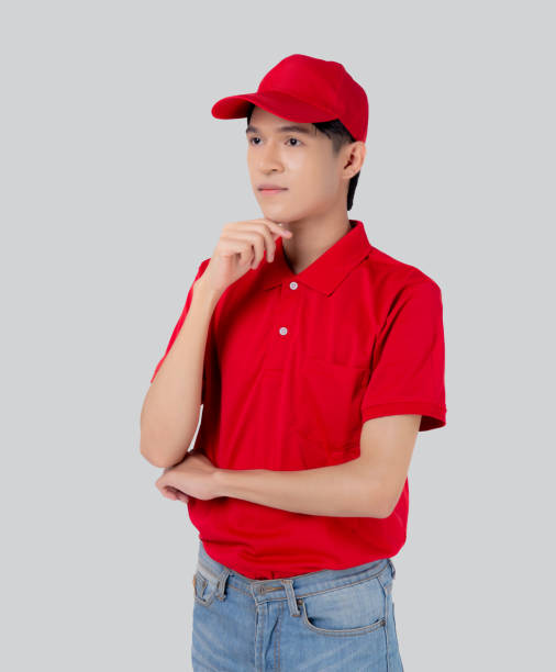 istock Young asian man in uniform red and cap standing and thinking idea isolated on white background, employee or dealer, courier and delivery, deliveryman and expression, logistic and cargo. 1466159654