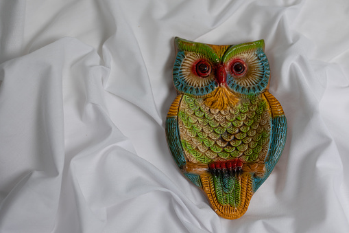 Ceramic owl bird on white background.