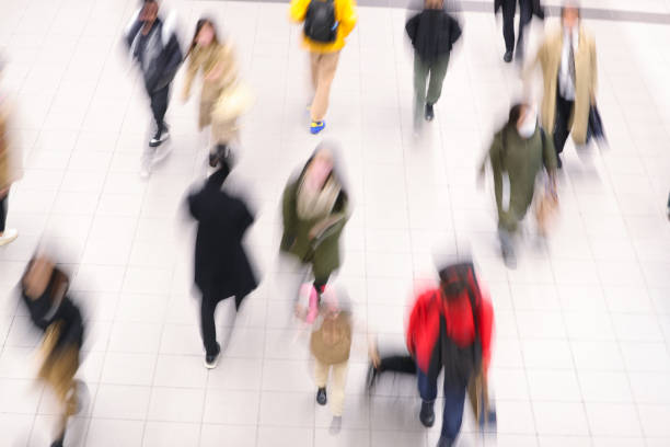 istock Blurred moving groups of people 1466168075