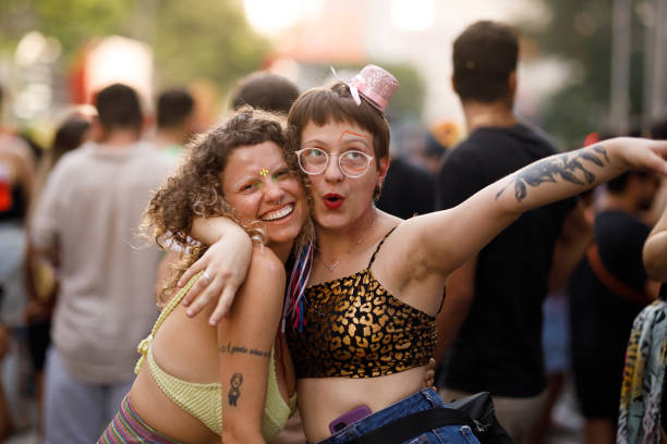 istock Happy friends embracing each other while having fun at a carnival party 1466180203