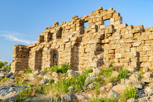 Awesome view of the ancient city walls in Side, Turkey. The amazing ruins are a popular tourist attraction of the world.