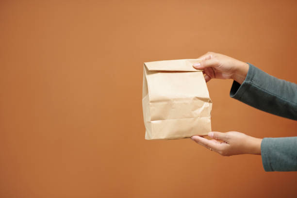 istock Woman Holding Paper Package 1466188361