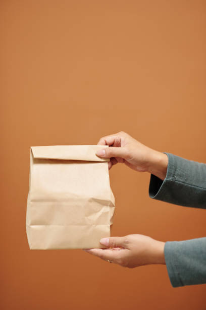 istock Woman Giving Paper Package 1466188393