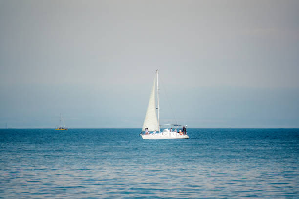 Sailing yacht in the blue calm sea. Yacht in peaceful waters.