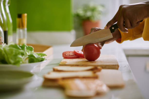 istock Woman Cutting Fresh Tomatoes 1466206851