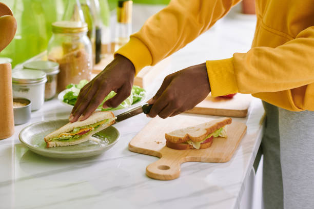 Woman Putting Sandwich on Plate