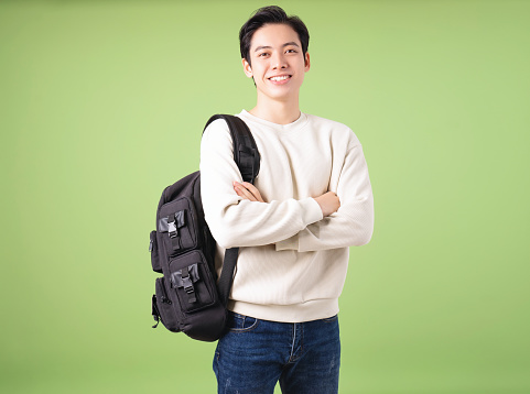 Image of young Asian student on background