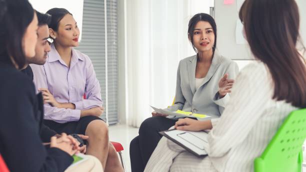 istock Business people proficiently discuss work project while sitting in circle . Corporate business team collaboration concept . 1466228905