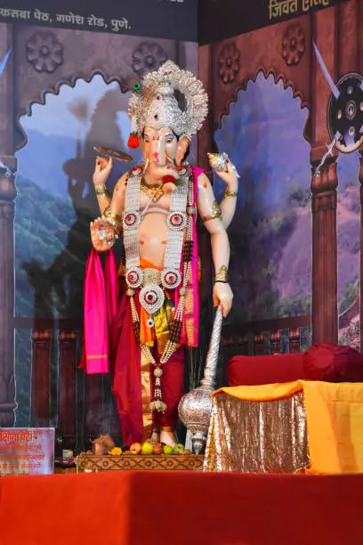 Photo of Standing Ganesha murti, Hindu Lord of Success, statue in a pandal during Ganesh Utsav festival at Pune, Maharashtra.